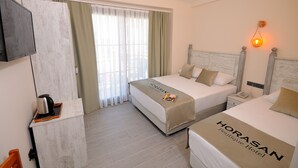 A hotel room with two beds, a minibar, a TV, and a window with curtains. - Horasan Hotel (Cesme)