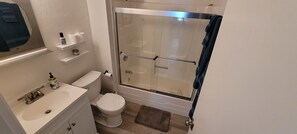 Combined shower/bathtub, towels, soap, toilet paper