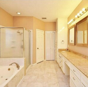 Bathroom features a bathtub and vanity with mirror.