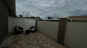Relax in a serene, patio with a comfortable seating area.