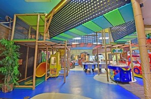 Kids can play and climb on the multi-level structure with a netted enclosure for safety.