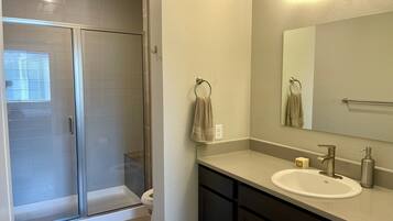 Combined shower/bathtub, towels, soap, toilet paper