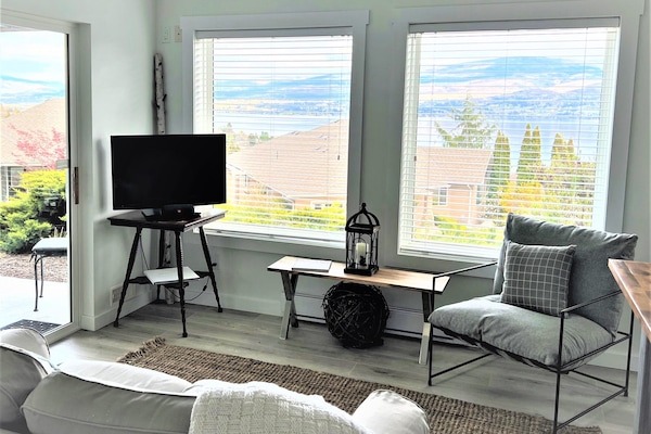 Living room with a lake and vineyard view