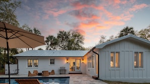 A house with a pool, outdoor seating, and a patio area. - Sawyer by AvantStay | Stunning Isle Of Palms Home w/ Pool! (Isle Of Palms)