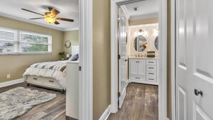 A bedroom with a bed, a ceiling fan, a window with blinds, and a fluffy rug. - Beautiful Waterfront Pool Home | Close to Golf & Beaches | Dog Friendly | Free Wifi | Dock (Palm Coast)