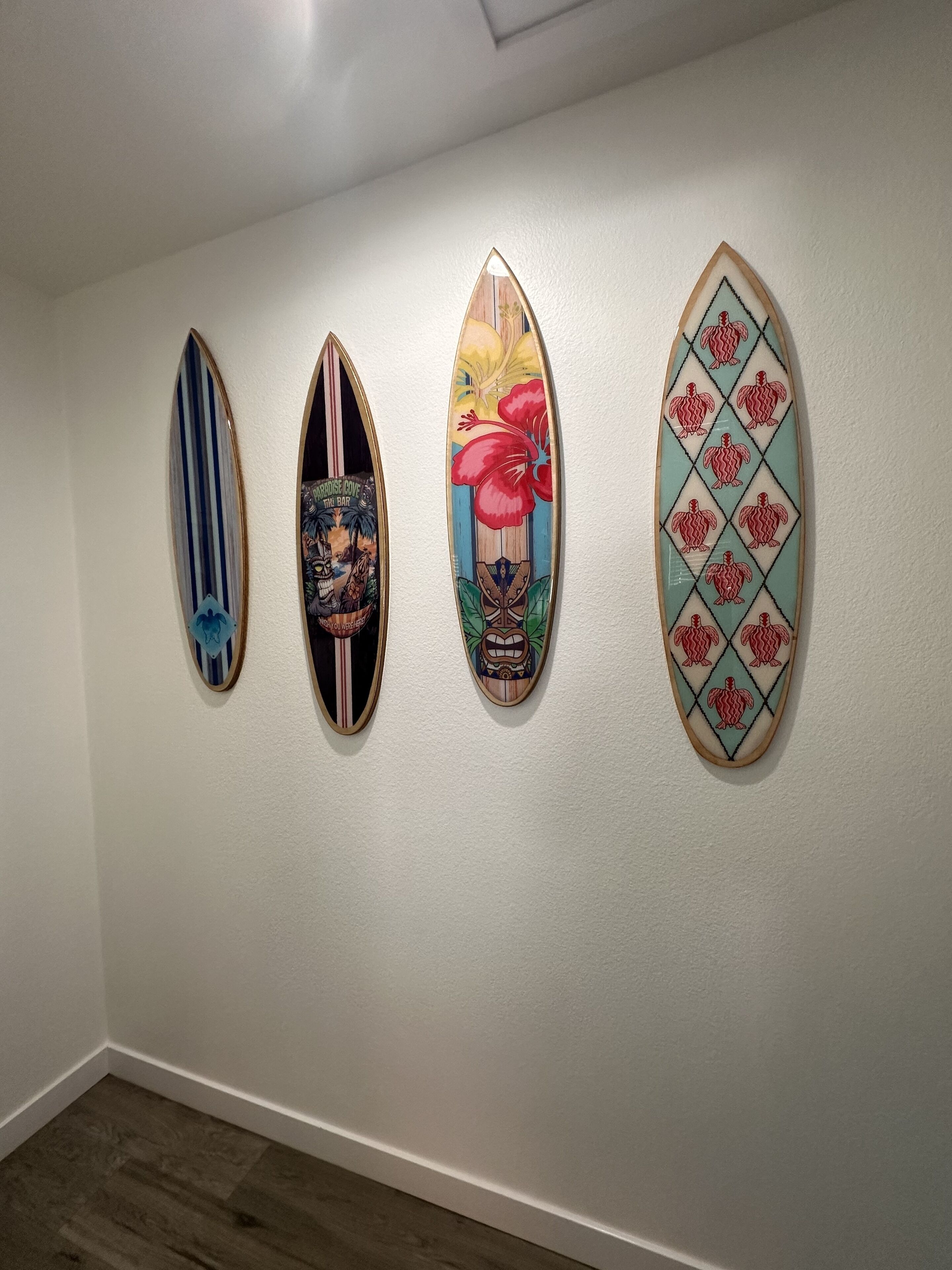 Four surfboards on a wall.
