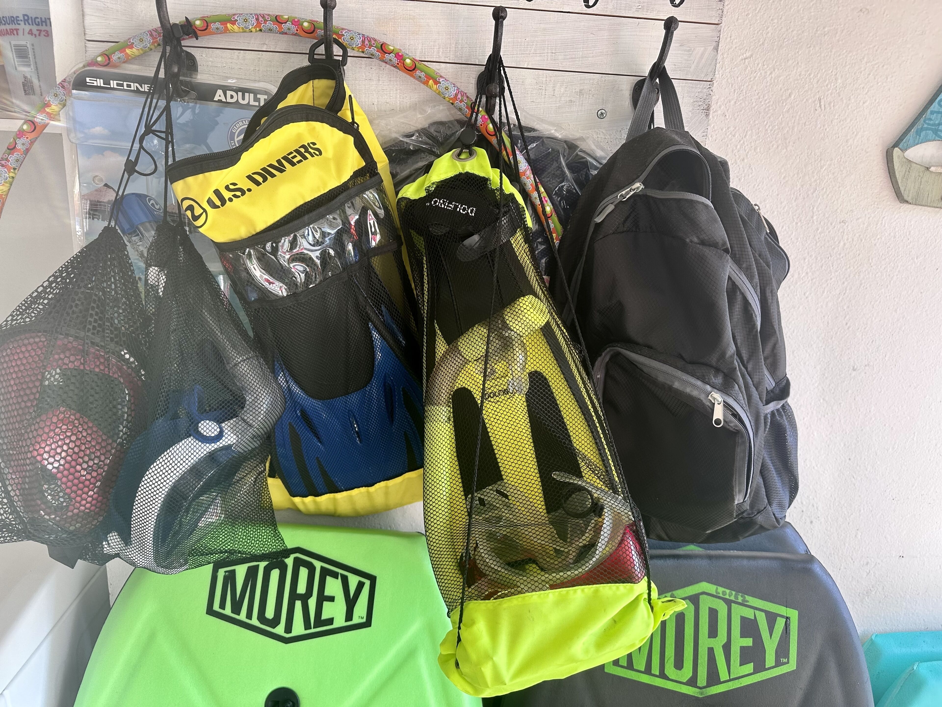 A rack with various bags and a green Morey bag.