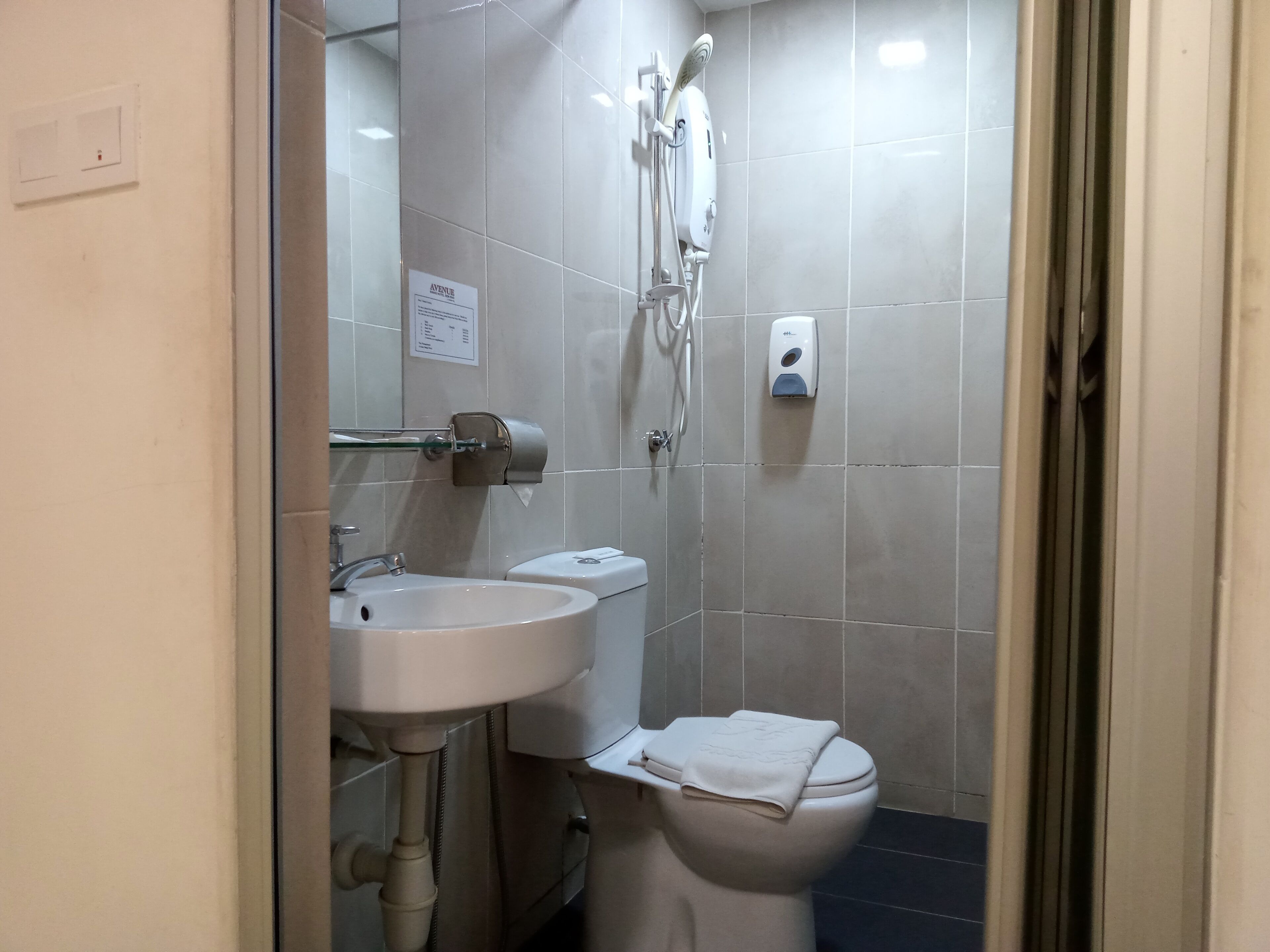 A bathroom with a sink, toilet, and shower.