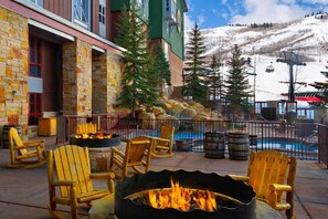 Relax by the fire pit in a serene mountain setting, surrounded by Adirondack chairs.