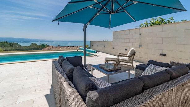 A rooftop terrace with a pool, outdoor furniture, and a view of the sea. - Nice home in Bregi with sauna (Bregi)