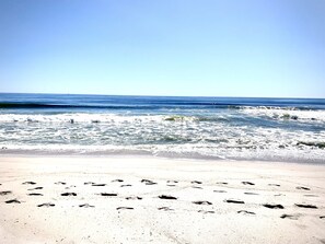 A beach with footprints leading to the water. - The Lighthouse- Gameroom, RooftopDeck! Beach badges,chairs,cart incld (Seaside Heights)