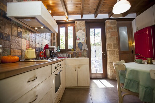 Enjoy cooking in this well-equipped kitchen with an oven, sink, and refrigerator.