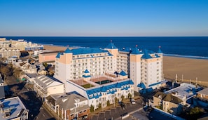 A coastal hotel with multiple blue-roofed towers, a beach view, and a parking area. - Belmont Towers 603 by Seaside Vacations & Sales (Ocean City)