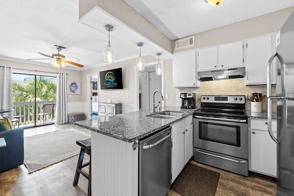 Whip up meals in style with this open-concept kitchen and breakfast bar.