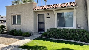 A two-story house with a tiled roof, a front door, and a small front yard with a hedge. - Wonderful 3 bedroom/2 bath, close to everything! (Scottsdale)