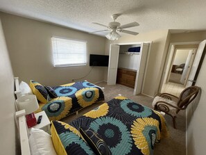 Cozy retreat with a single bed, bedside tables, and a walk-in closet.
