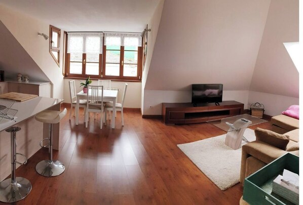 Relax in this stylish living space with a dining area, seating area, and flat-screen TV.