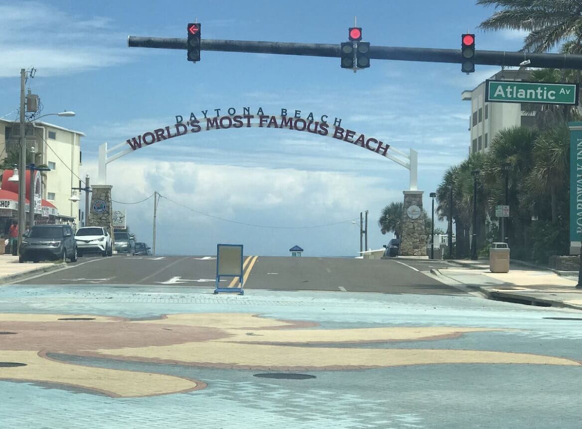 A street view with a traffic light and a sign reading "Atlantic Ave."