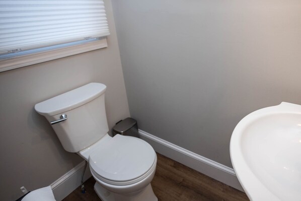 A small bathroom with a toilet, a bidet, and a sink.