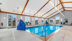 An indoor swimming pool with a clear view of the pool area, a fire extinguisher, and a covered entrance. - APPresSki - 5 bed Ski in Ski out - 50 Steps to Ski Sugar Mountain Slopes (Sugar Mountain)