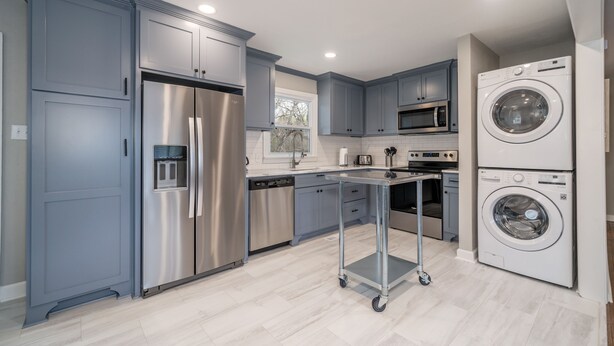 A modern kitchen with stainless steel appliances, grey cabinets, and a built-in washing machine. - NEW! Completely renovated 2bed/1bath UPTOWN home! (Hot Springs National Park)