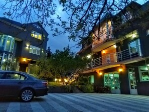 Stunning two-story building with a spacious balcony and large windows, offering a beautiful view.