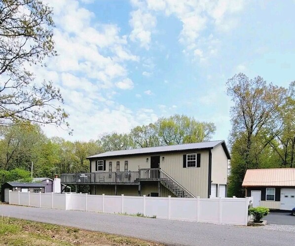 Stroll up to this charming two-story home with a spacious balcony overlooking a serene suburban setting.