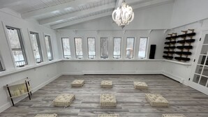 A spacious room with a high ceiling, large windows, and a chandelier. - ◆DREAM Modern Cabin in the Woods ◆ Hot tub + Sauna (Hunter)