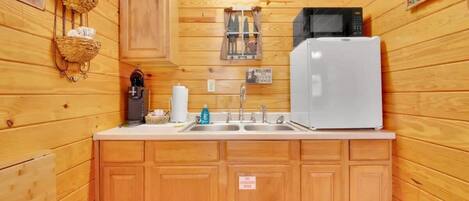 Fridge, microwave, coffee/tea maker, cookware/dishes/utensils