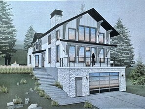 Overlooking a serene lake, this house features a large balcony and a well-maintained pathway leading to the entrance.