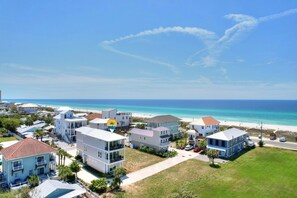 A coastal residential area with houses, a beach, and a clear sky. - Shore to Please! Laguna Beach, Fl. Pet friendly! Across the street to the beach (Panama City Beach)