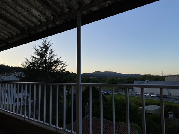 A balcony with a view of a road and distant mountains. - Padrón Centro, Camino De Santiago (Padrón)