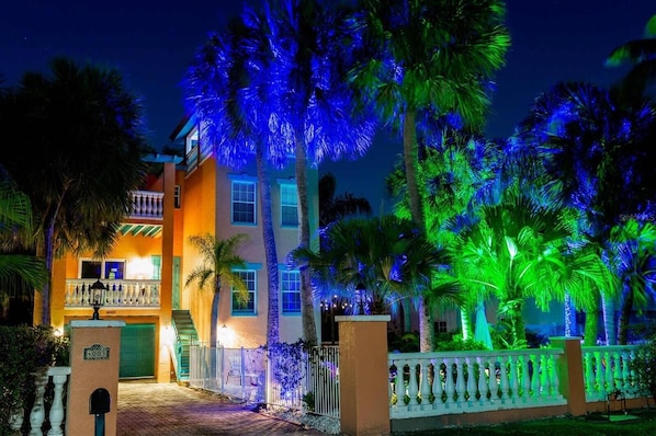 A multi-story building with balconies and a gated entrance.