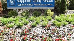 A sign for Sapphire Valley Resort with a logo and text indicating it is a vacation ownership resort.