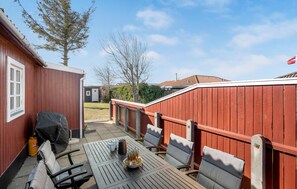 Enjoy dining and socializing in this patio area, complete with a barbecue grill and comfortable seating for six.