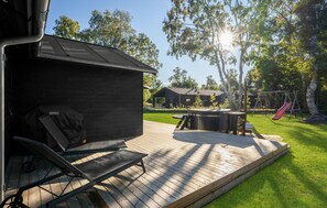 A deck with a hot tub, lounge chairs, and a barbecue grill. - Cozy home in Grenaa with kitchen (Grenaa)
