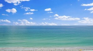 A beach with clear turquoise water and a sandy shore.
