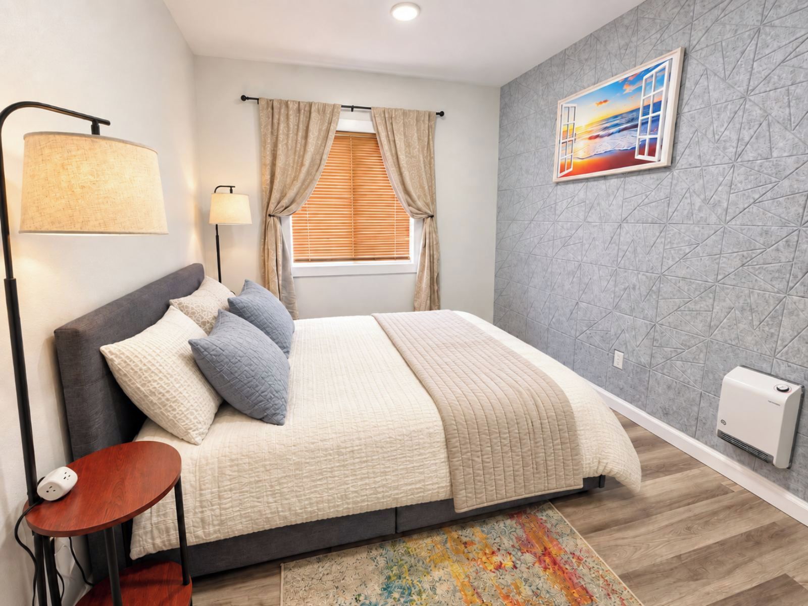Un dormitorio moderno con cama, lámpara de noche, ventana con cortinas y un cuadro en la pared.