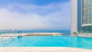 A swimming pool with a view of the beach and city skyline. - DHH Bluewater Island Building 2 Sea View (Dubai)