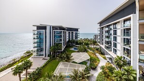A modern hotel with multiple floors, large glass windows, and a view of the sea. - DHH Bluewater Island Building 2 Sea View (Dubai)