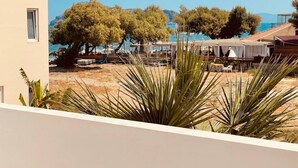 Una propietat a la platja amb zona de terrassa, mobiliari exterior i vista al mar.