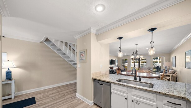 A modern kitchen with granite countertops, stainless steel appliances, and pendant lighting. - 4C, Meet Me at The Gulf (Miramar Beach)