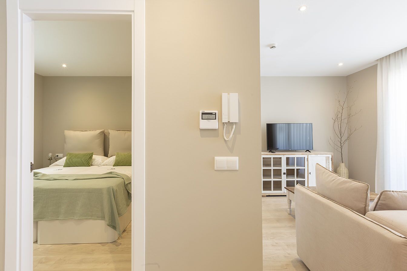 A modern living room with a sofa, a television, and a cabinet.