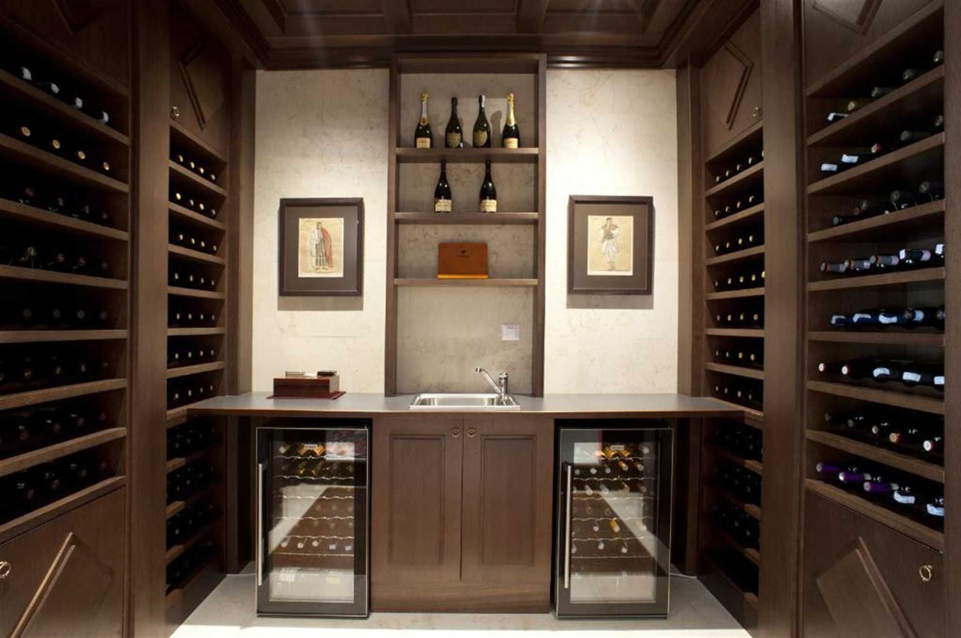 A wine cellar with wooden shelves and a central counter.