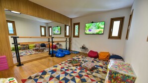 A room with a foosball table, exercise balls, and a colorful geometric rug. - Dulcinea  Dream  Villa (Ulcinj)