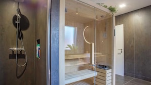 A modern bathroom with a glass-enclosed shower, wooden shelves, and a visible door. - Authentic Mountainside Villa Lusso (Zabljak)