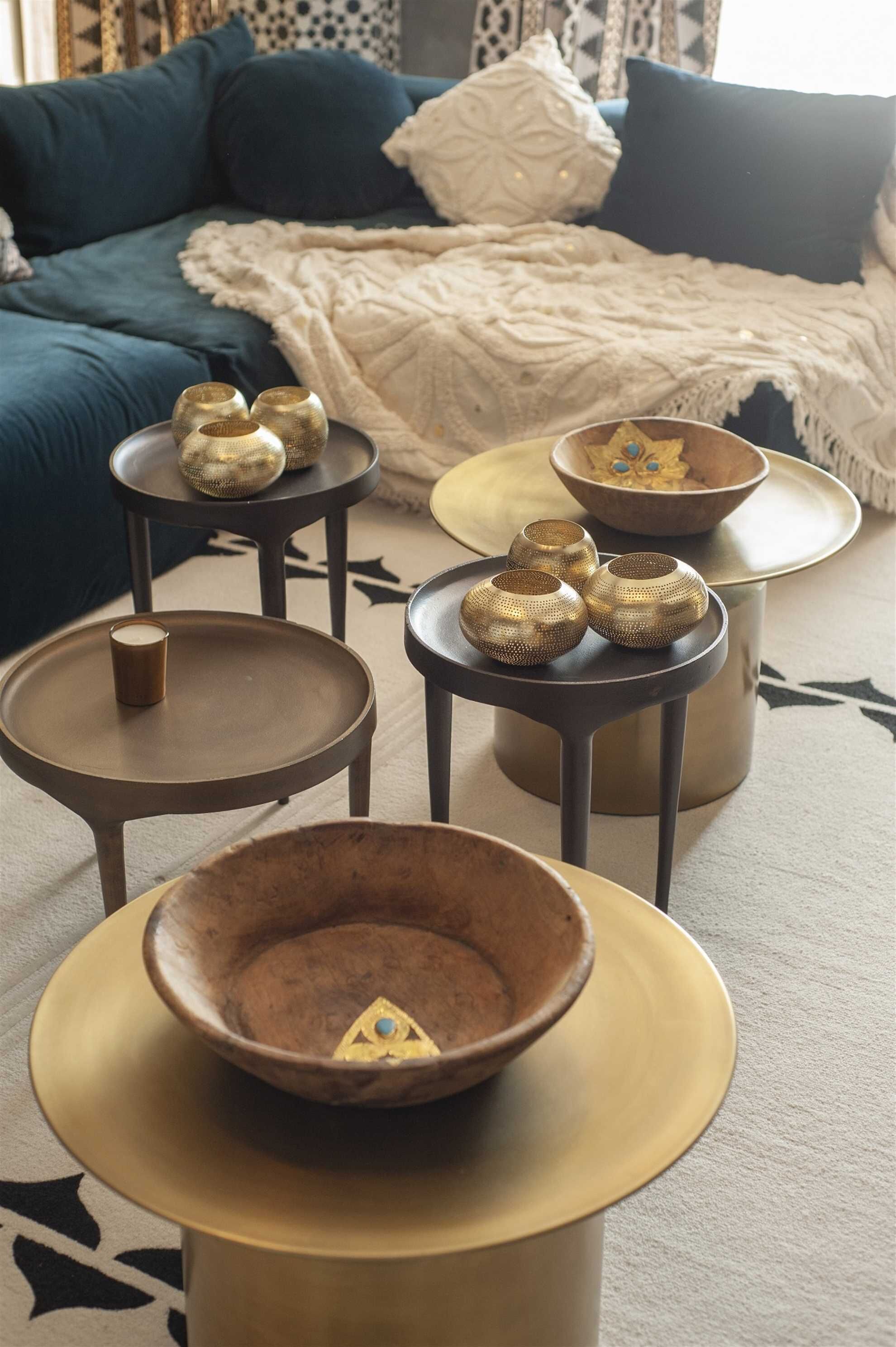 A living room with a sofa, coffee table, and decorative bowls.