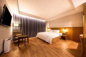 Relax in a stylish room with a comfortable bed, flat-screen TV, and seating area.