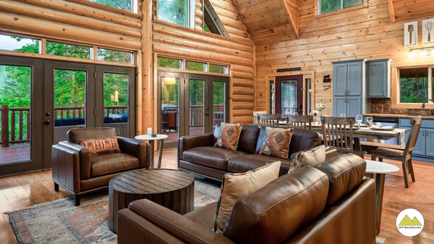 A spacious log cabin interior with a large living area, dining space, and a kitchen. - Secluded|5 Min to Twn|Game Rm|Kid-Friendly Escape (Pigeon Forge)