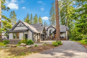 Stunning two-story home surrounded by mature trees and beautifully landscaped grounds.
